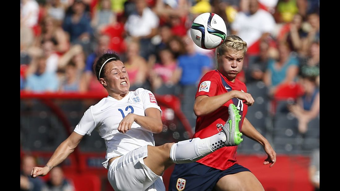 Hegerberg vies for the ball with Lucy Bronze, left.