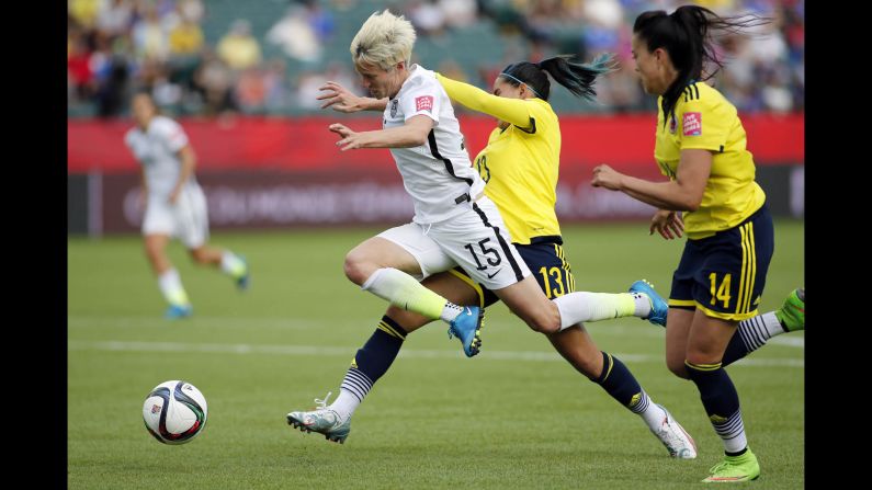 U.S. midfielder Megan Rapinoe is fouled by Colombia defender Angela Clavijo during a <a href="index.php?page=&url=http%3A%2F%2Fwww.cnn.com%2F2015%2F06%2F06%2Fsport%2Fgallery%2Fwomen-worlds-cup-2015%2Findex.html" target="_blank">Women's World Cup</a> match in Edmonton, Alberta, on Monday, June 22. The foul was in the box, leading to a penalty that Lloyd converted into a goal. The United States won the match 2-0 to advance to the quarterfinals.