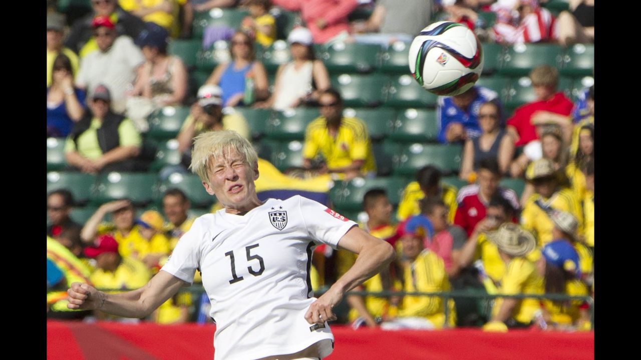 Rapinoe heads the ball against Colombia.