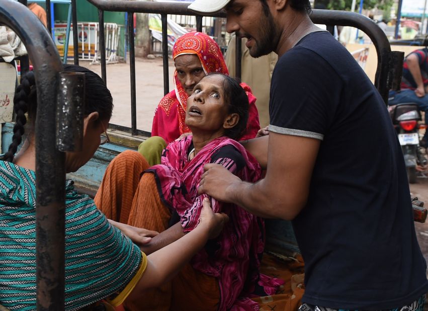 A man helps move a heat wave victim to a Karachi hospital on Monday, June 22.