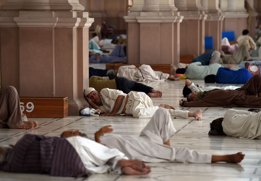 Pakistanis rest at the mosque during the heat wave in Karachi on June 22.