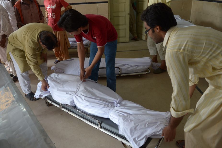 Pakistani volunteers and relatives prepare to shift the bodies of heat wave victims into the cold storage of the Edhi morgue in Karachi on June 22.