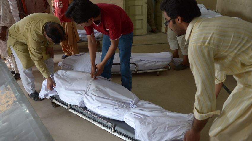 Pakistani volunteers and relatives prepare to shift the bodies of heatwave victims into the cold storage of the Edhi morgue in Karachi on June 22, 2015.