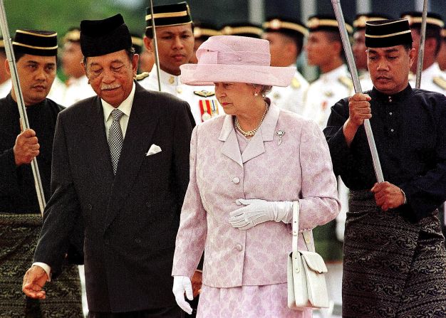 Queen Elizabeth II is escorted by Malaysia's King Jaafar during the official welcoming ceremony in Kuala Lumpur in September 1998. She visited Malaysia on that occasion to officiate the closure of the XVI Commonwealth Games. 