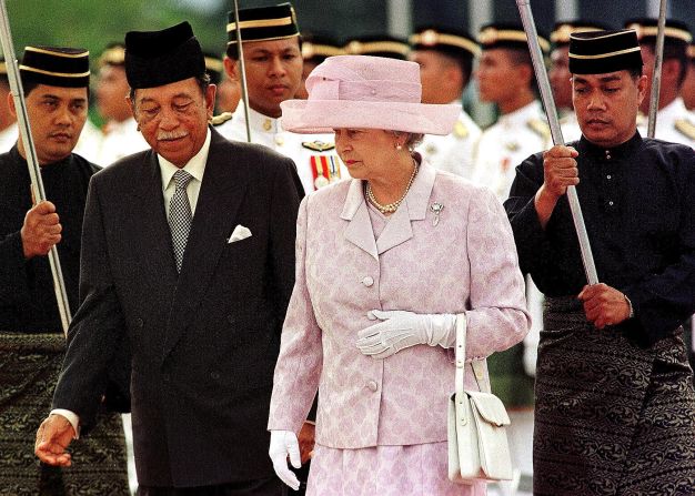 Queen Elizabeth II is escorted by Malaysia's King Jaafar during the official welcoming ceremony in Kuala Lumpur in September 1998. She visited Malaysia on that occasion to officiate the closure of the XVI Commonwealth Games.