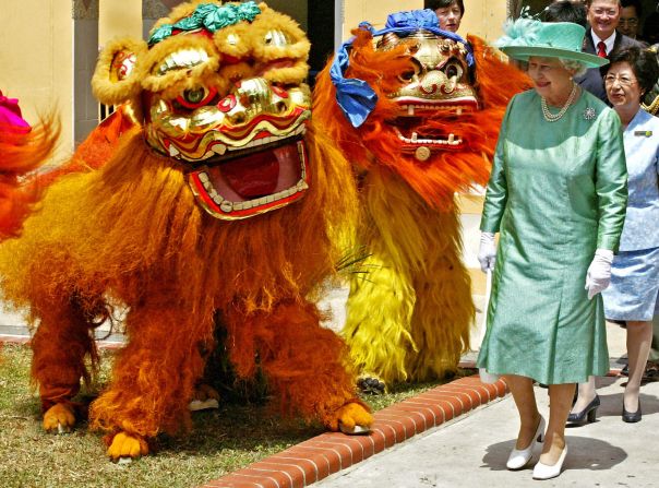 Visiting the former British colony of Singapore in March of 2006, Queen Elizabeth II watches a Chinese Lion Dance troop perform at the Toa Payoh Housing Development Board estate.  