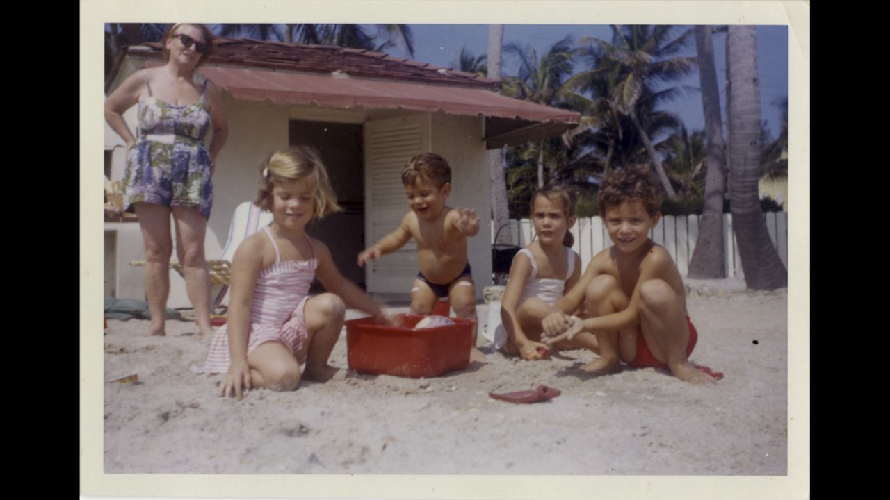 Caroline and John F. Kennedy Jr. playing in the sand with friends in May 1962.