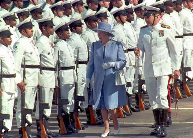 On her first state visit to South Africa, the Queen inspects the guards of honor at Cape Town's waterfront in March 1995.