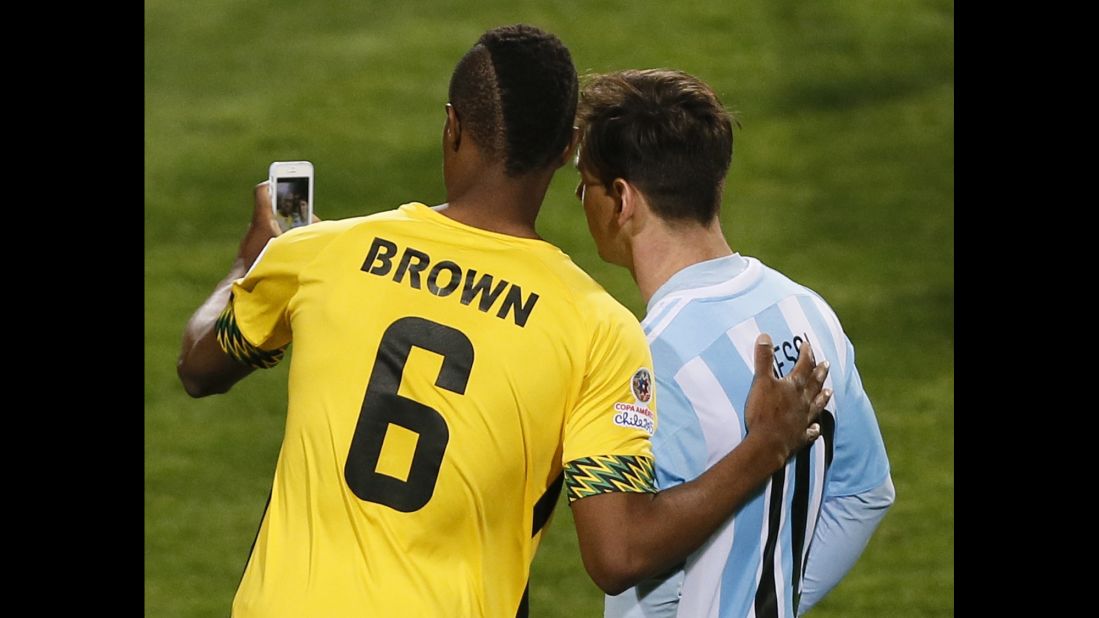 Jamaica's DeShorn Brown snaps an on-field selfie with Argentina's Lionel Messi after a first-round match at the Copa America on Saturday, June 20.