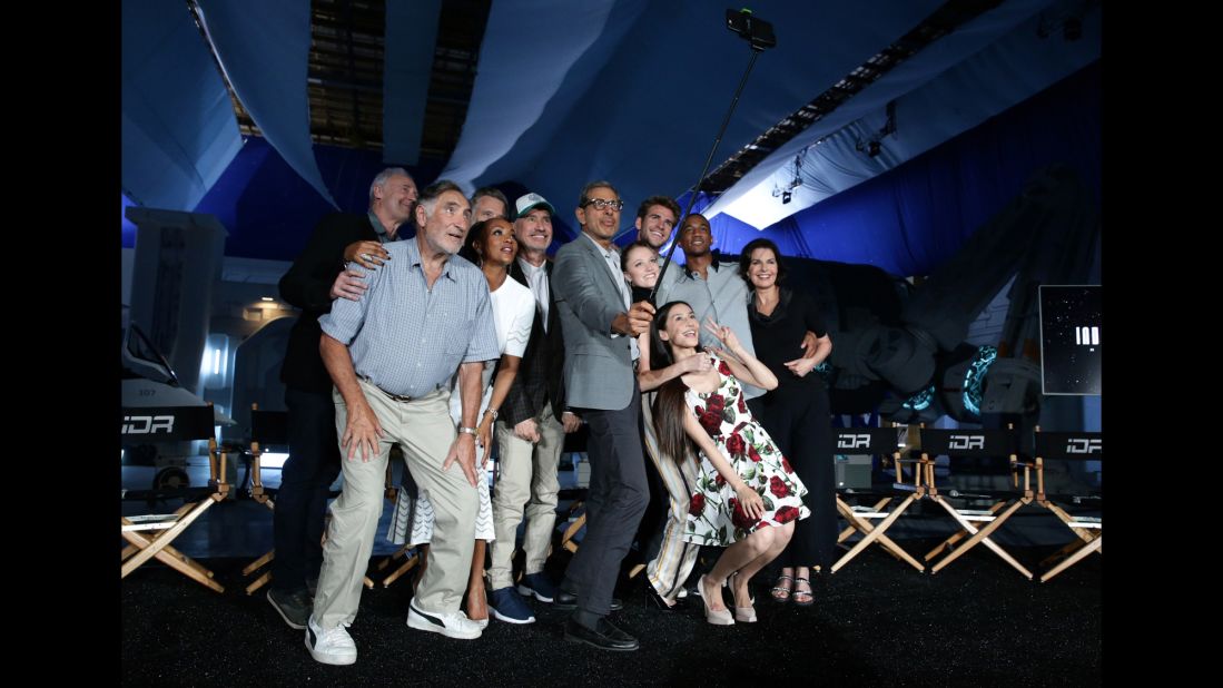 Actor Jeff Goldblum uses a selfie stick to get a photo with the cast of the upcoming film "Independence Day Resurgence" on Monday, June 22. Behind Goldblum, from left, are Brent Spiner, Judd Hirsch, Bill Pullman, Vivica A. Fox, director Roland Emmerich, Maika Monroe, Liam Hemsworth, Grace Huang, Jessie Usher and Sela Ward.