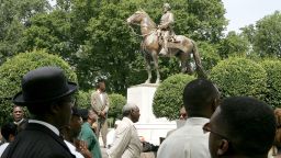 MEMPHIS, TN - AUGUST 13: Protesters attend a rally protesting against the name of Nathan Bedford Forrest Park in front of a statue bearing his likeness August 13, 2005 in Memphis, Tennessee. Nathan Bedford Forrest was a Civil War General who led troops against the north. Forrest was originally buried in Elmwood Cemetery in Memphis. In 1905 Confederate veterans arranged to move his remains and those of his wife Mary to a new site, named Forrest Park, which is adorned with a statue of him riding a horse. (Photo by Carlo Allegri/Getty Images)