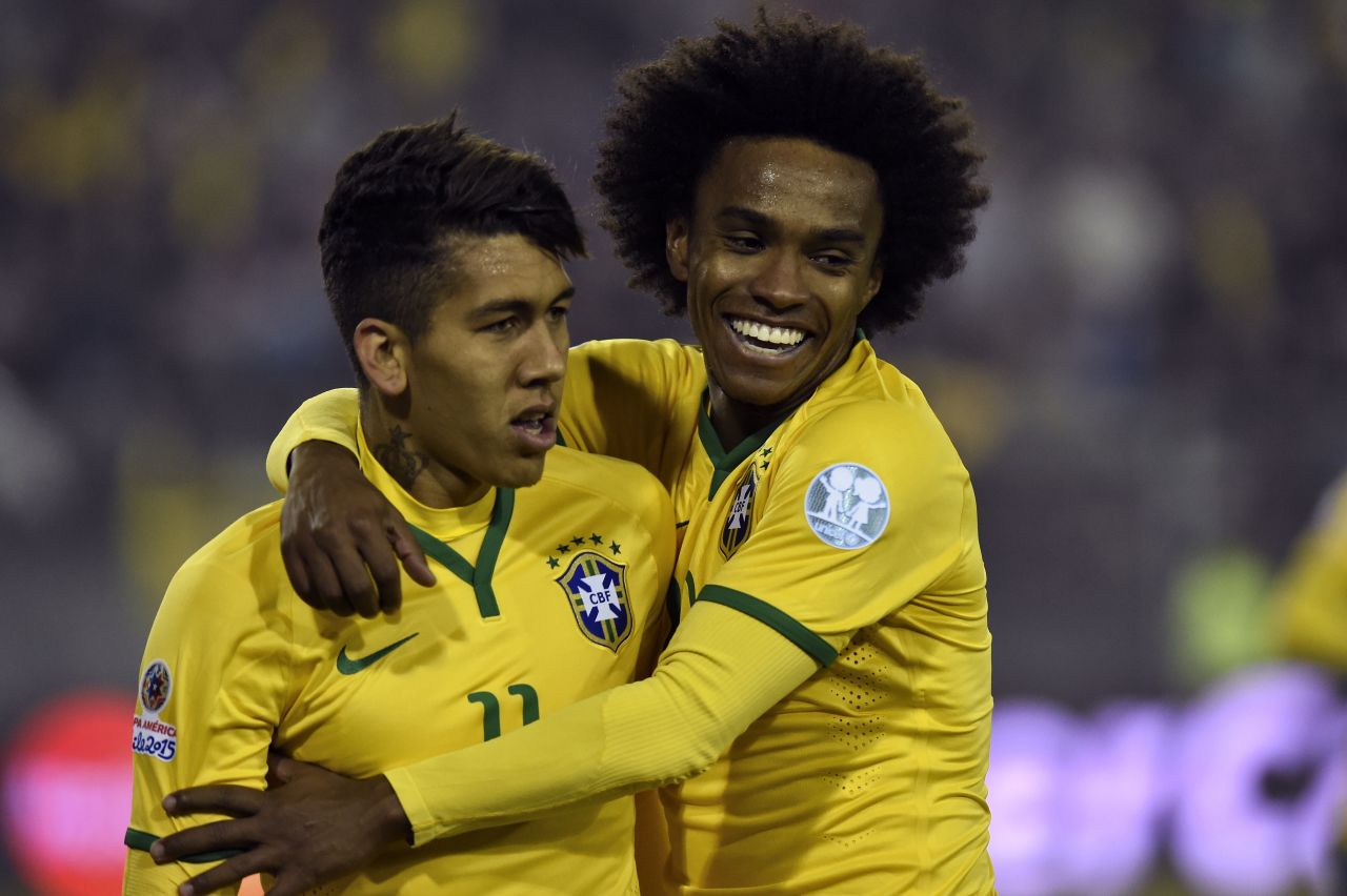 Firmino (left) is congratulated by his teammate Willian after scoring the winning goal against Venezuela in the Copa America. Liverpool have signed the 23-year-old for around $45 million from German Club Hoffenheim.