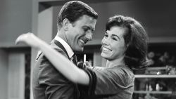 Dick Van Dyke as Rob Petrie and Mary Tyler Moore as Laura Petrie on the set.