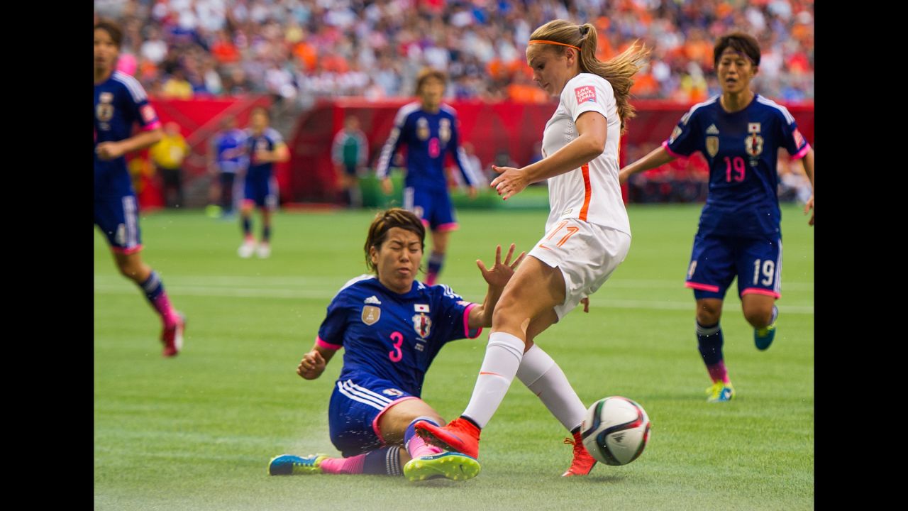 Japan's Azusa Iwashimizu knocks the ball away from Lieke Martens.
