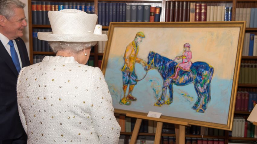 BERLIN, GERMANY - JUNE 24: President of Germany Joachim Gauck presents Queen Elizabeth II with a painting of her and Farther when she was a little girl at the Schloss Bellevue Palace on the second day of a four day State Visit on June 24, 2015 in Berlin, Germany. (Photo by Arthur Edwards - Pool/ Getty Images)