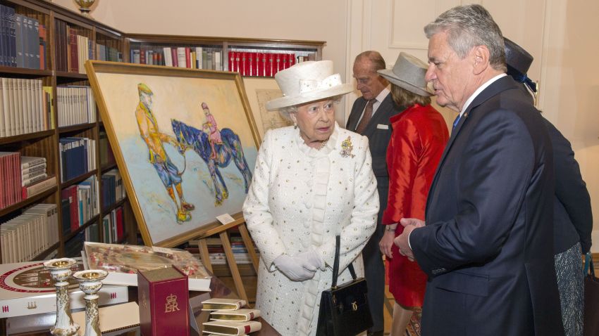 Queen Elizabeth II and Germany's Federal President Joachim Gauck exchange gifts at his official Berlin residence, Bellevue Palace, on the first full day of her state visit to Germany. A gift of a stylized painting of the Queen sat on a pony prompted the monarch to declare "that's a funny color for a horse" when the German president gave her the artwork.