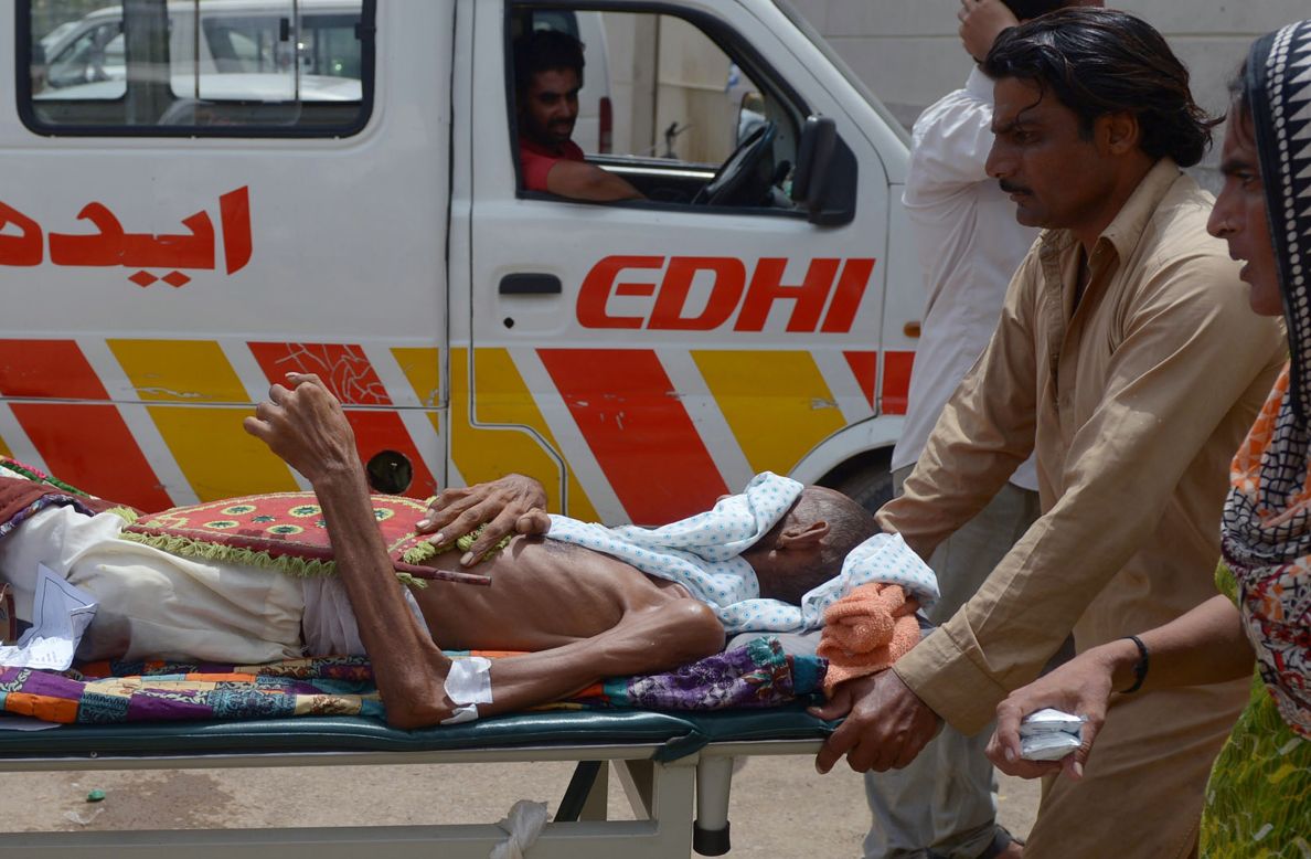 Pakistanis bring a heatstroke victim to a hospital in Karachi on Thursday, June 25. More than 1,000 people have died in a heat wave in southern Pakistan, officials say. 
