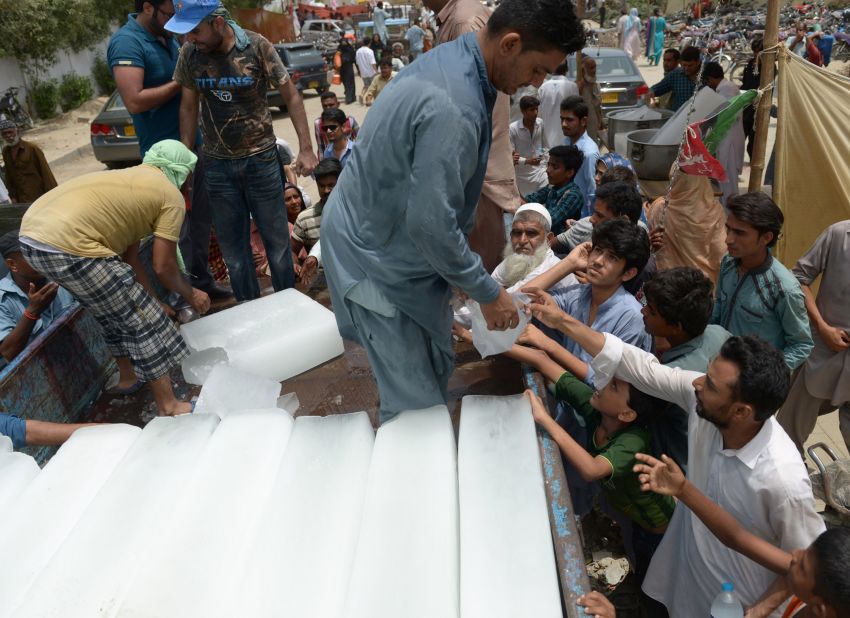 Pakistanis receive ice during the heat wave in Karachi on June 24.