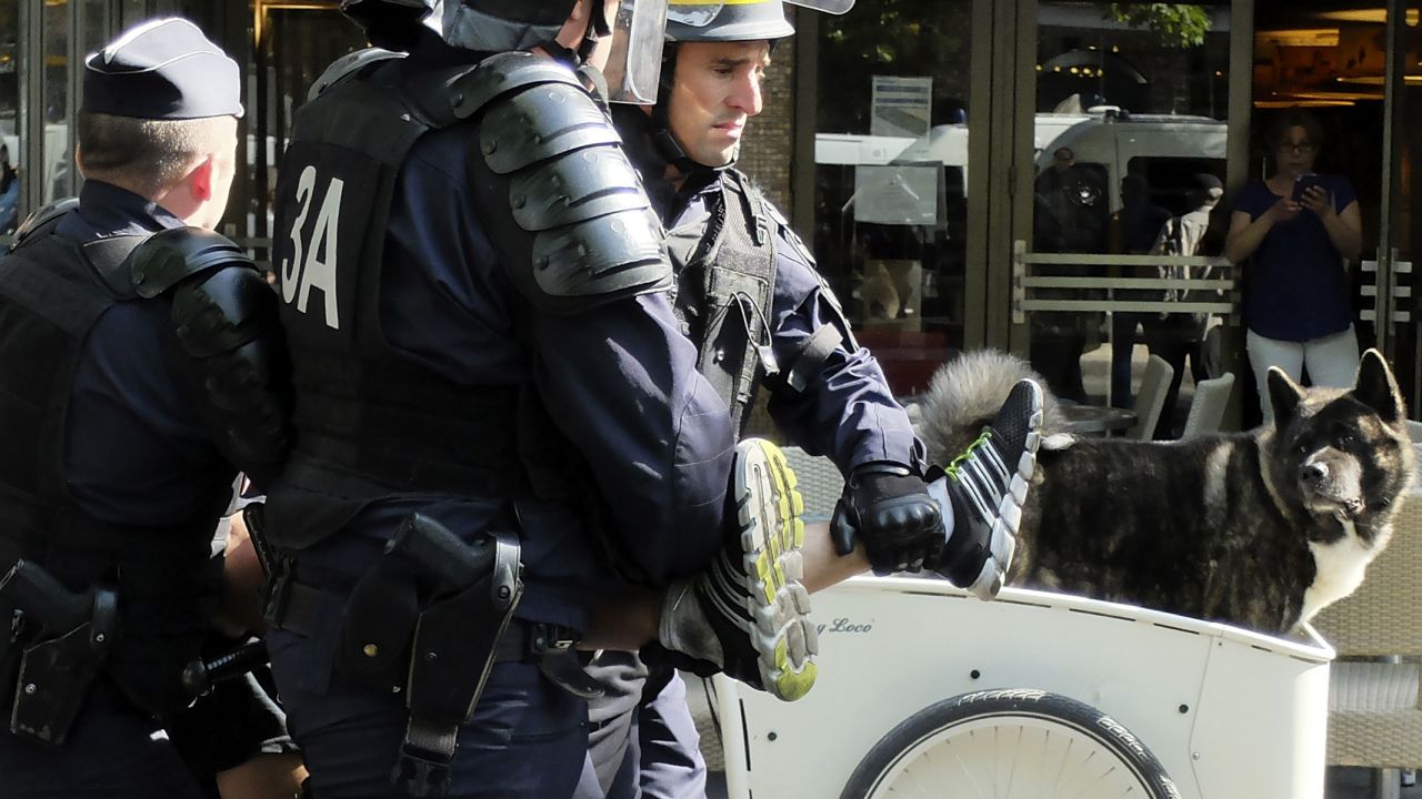 Police detain a protester in Paris on June 25.