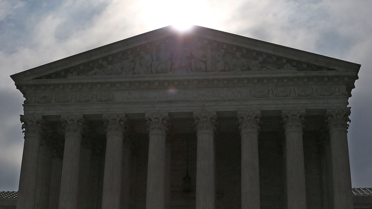 The early-morning sun rises behind the Supreme Court building June 18, 2015 in Washington, D.C. 
