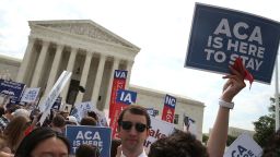 People celebrate in front of the US Supreme Court after ruling was announced on the Affordable Care Act June 25.