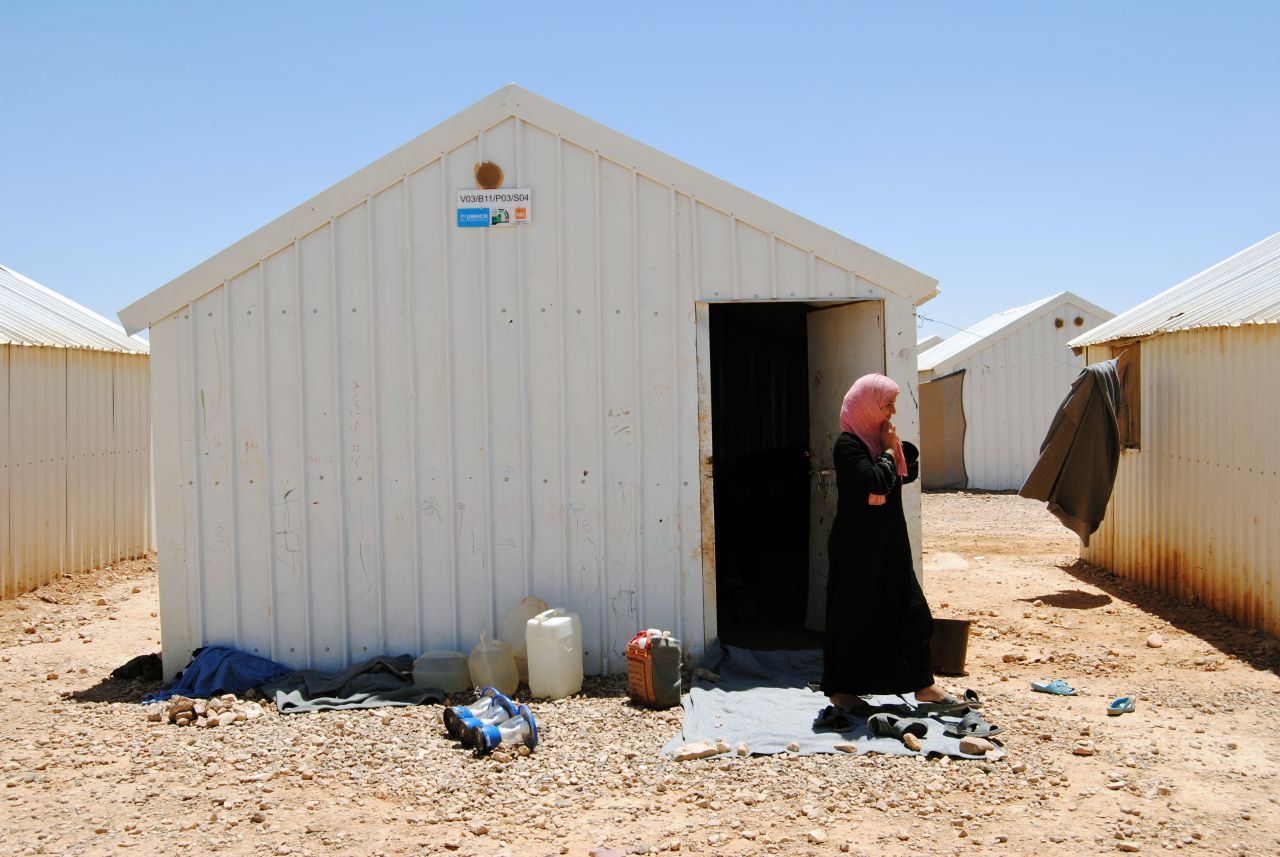 Sharouk, 15, lives in this metal box with her mother (pictured) and her two younger siblings.