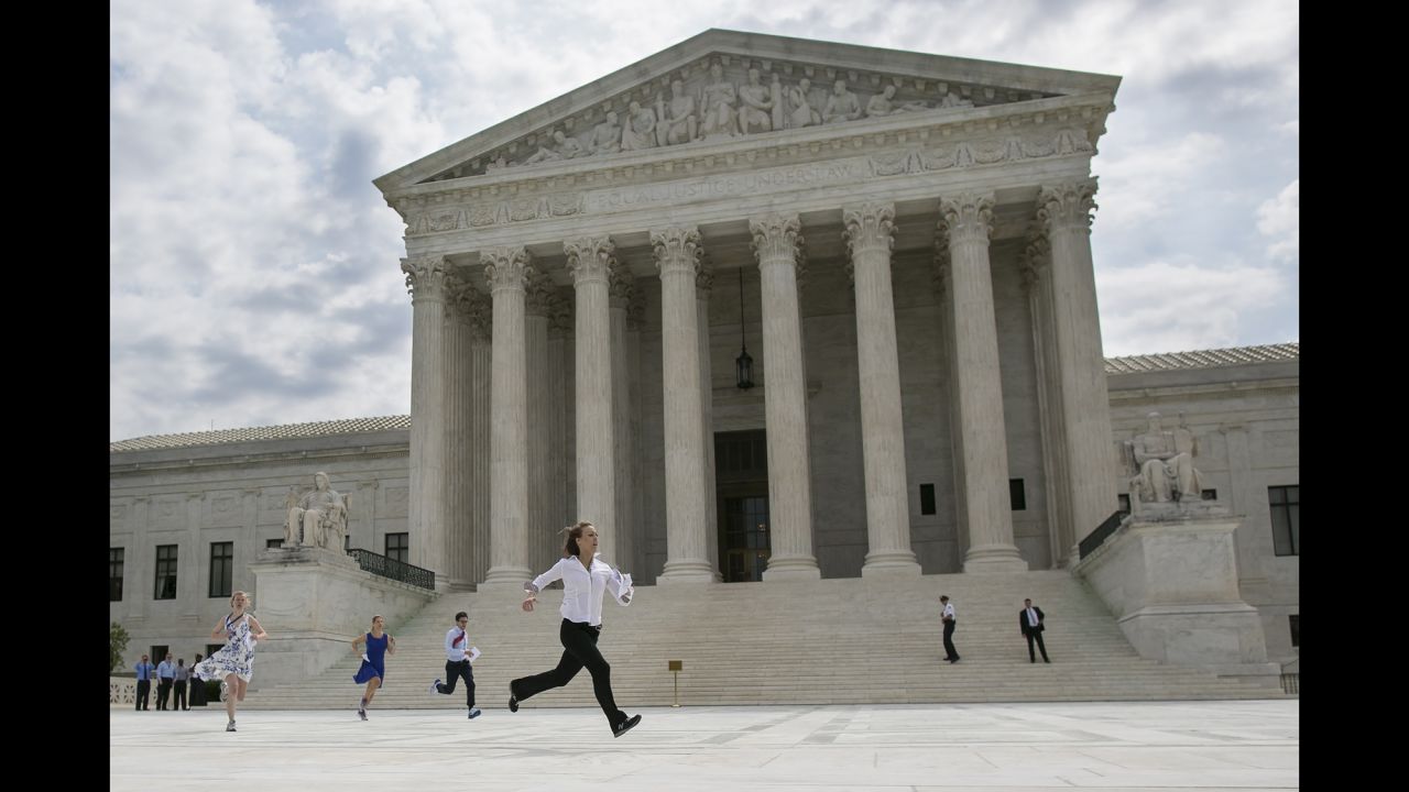 Members of the media run with Supreme Court decisions in hand Thursday, June 25, after <a href="http://www.cnn.com/2015/06/25/politics/supreme-court-ruling-obamacare/index.html" target="_blank">the court saved President Barack Obama's controversial health care law.</a>