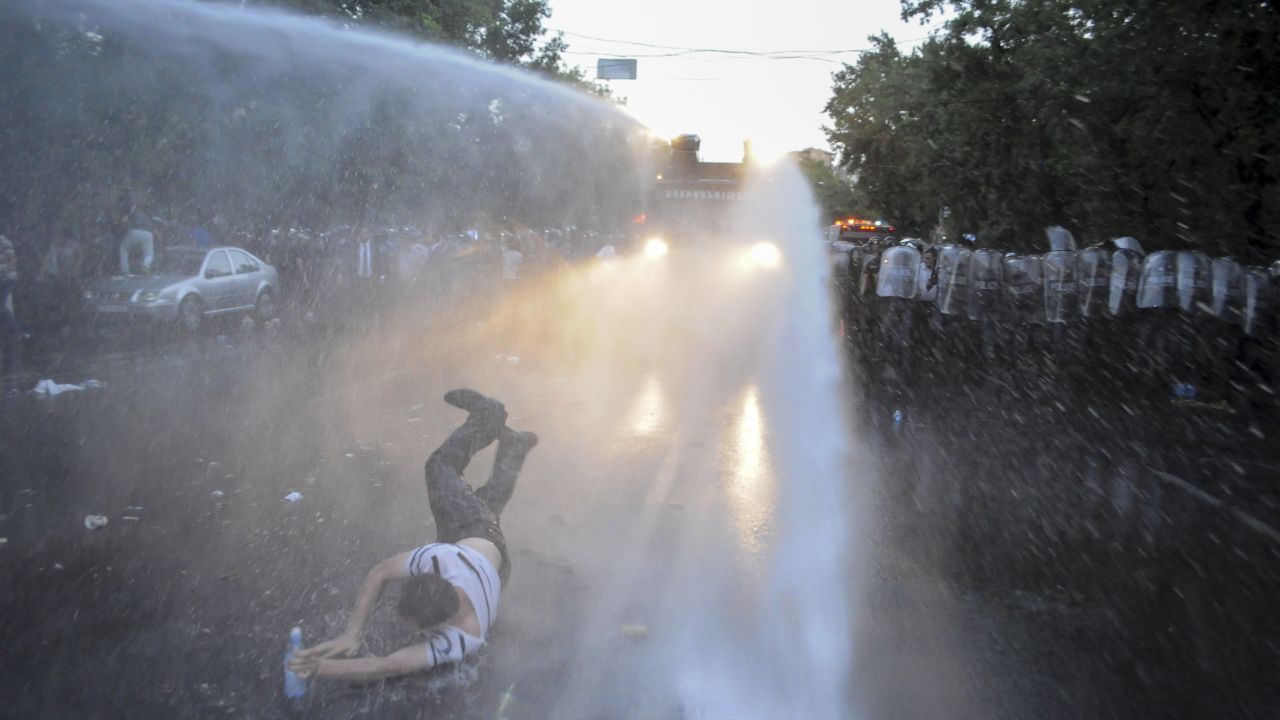 Police in Yerevan, Armenia, use water cannons to disperse people who were blocking a central avenue Tuesday, June 23, while protesting an increase in electricity prices.