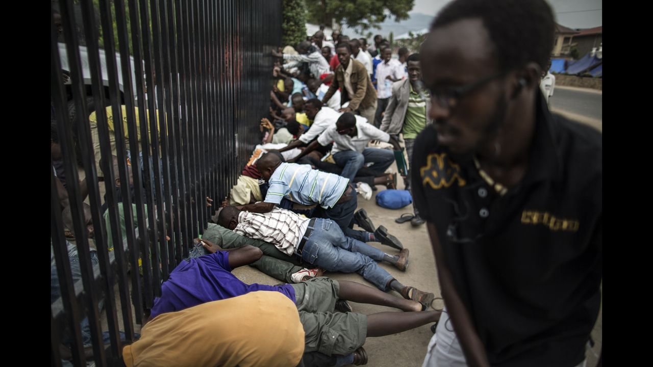 Students slide under the main access gate of the U.S. Embassy in Bujumbura, Burundi, after police threatened to break up their camp outside the compound on Thursday, June 25. The camp was established outside the embassy after violent protests began in the country in late April. <a href="http://www.cnn.com/2015/05/14/world/gallery/burundi-unrest/index.html" target="_blank">The protests happened</a> after Burundian President Pierre Nkurunziza expressed his intention to run for a third term. There was also a failed coup attempt.