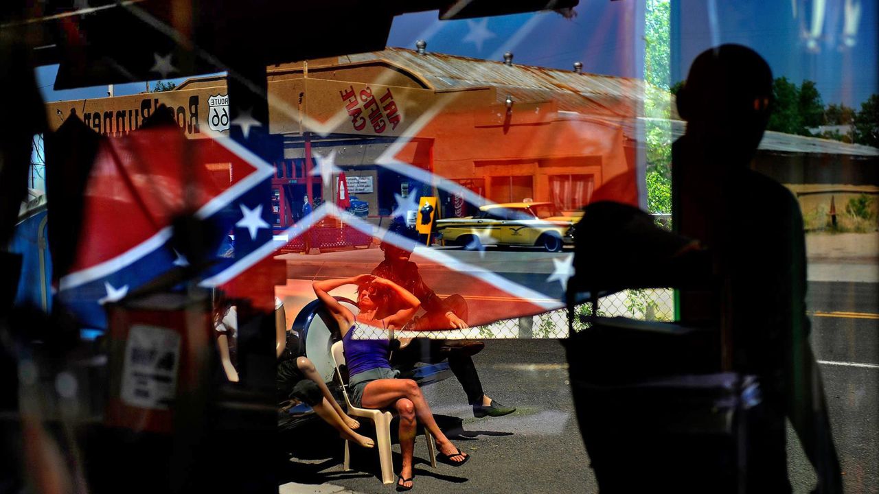 A Confederate flag is reflected in a gift shop window Sunday, June 21, in Seligman, Arizona. The June 9 church shooting in Charleston, South Carolina, <a href="http://www.cnn.com/2015/06/24/us/confederate-flag-myths-facts/index.html" target="_blank">has tipped the balance</a> in a decades-old tug of war over the meaning of the flag. Its champions have argued it's a symbol of Southern culture, the historic flag of the South. Critics say it's a racist symbol that represents a war to uphold slavery and, later, a battle to oppose civil-rights advances.