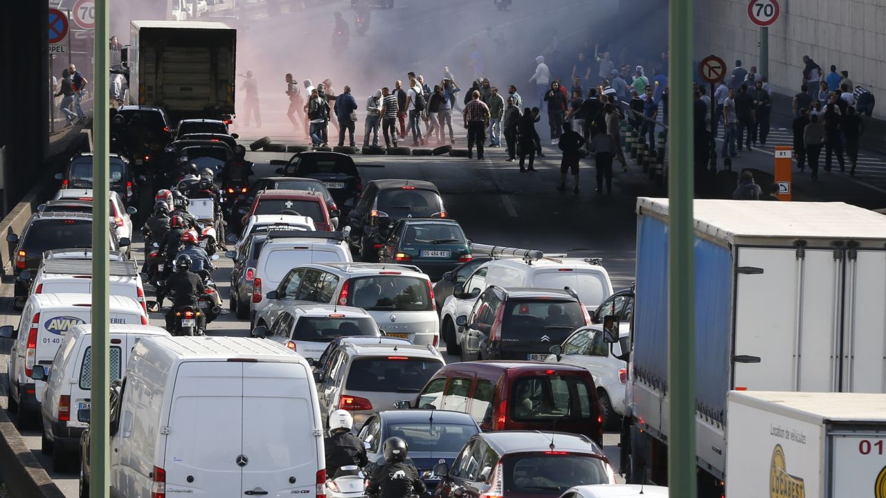 Striking taxi drivers block the Boulevard Peripherique in Paris as they <a href="http://www.cnn.com/2015/06/25/europe/france-paris-uberpop-protests/index.html" target="_blank">protest the online ride service UberPOP</a> on Thursday, June 25. UberPOP, which operates in more than a dozen cities across Europe, gives passengers a cheaper alternative to traditional taxis by letting private drivers offer rides. The UberPOP app was ruled illegal by the French government last year, but the company hasn't yet exhausted all legal recourse.