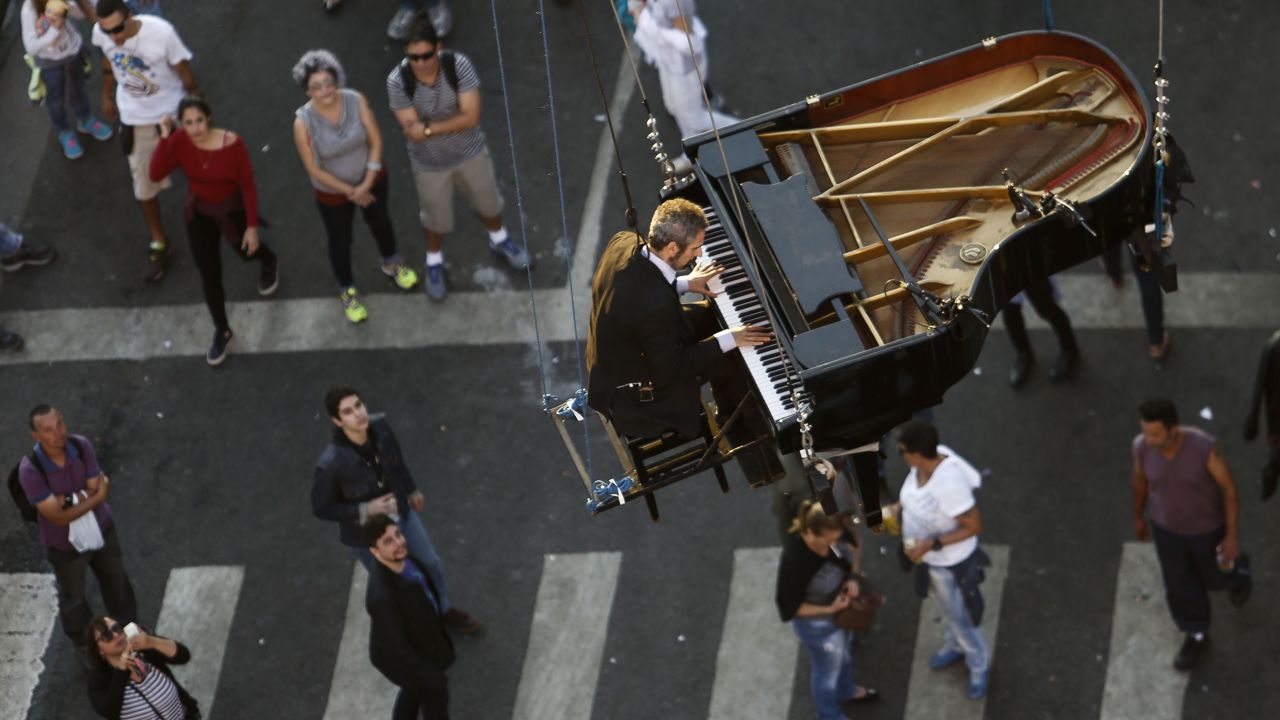 Ricardo de Castro Monteiro performs on a hanging piano during the annual Virada Cultural event Sunday, June 21, in Sao Paulo, Brazil.