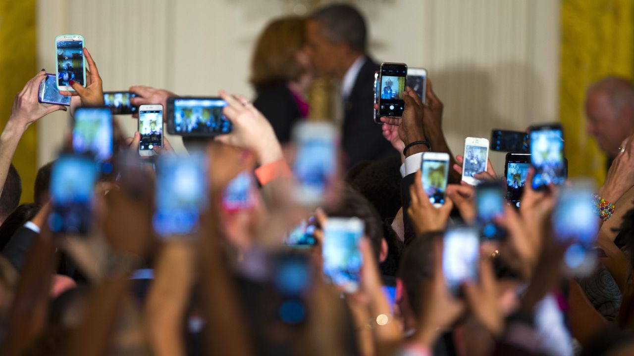 White House guests hold up cell phones Wednesday, June 24, as Megan Smith, the United States' chief technology officer, greets President Barack Obama as he arrives for a reception to celebrate LGBT Pride Month.
