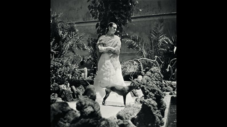Kahlo stands in her garden with her dogs in 1951. 