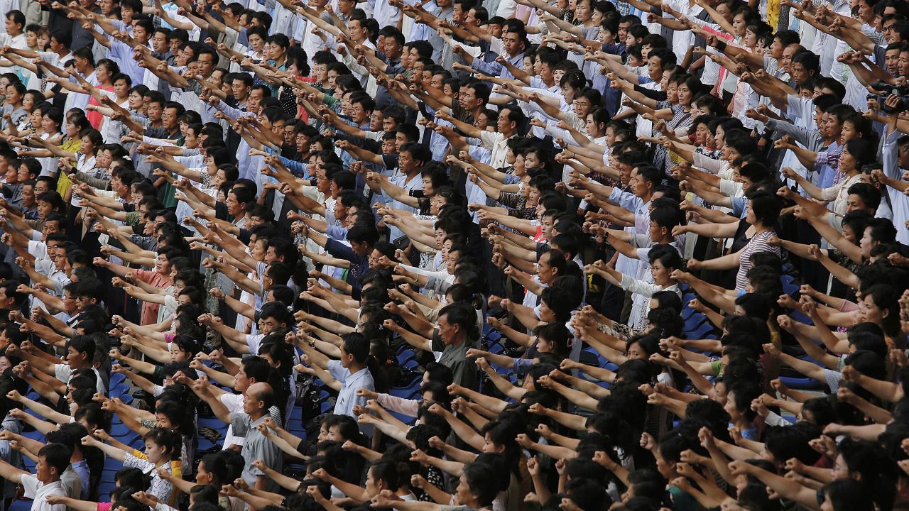 Men and women at a stadium in Pyongyang, North Korea, pump their fists in the air and chant "Defend!" on Thursday, June 25, during the "Pyongyang Mass Rally on the Day of the Struggle Against the U.S." The rally was attended by approximately 100,000 North Koreans to mark the 65th anniversary of the outbreak of the Korean War.