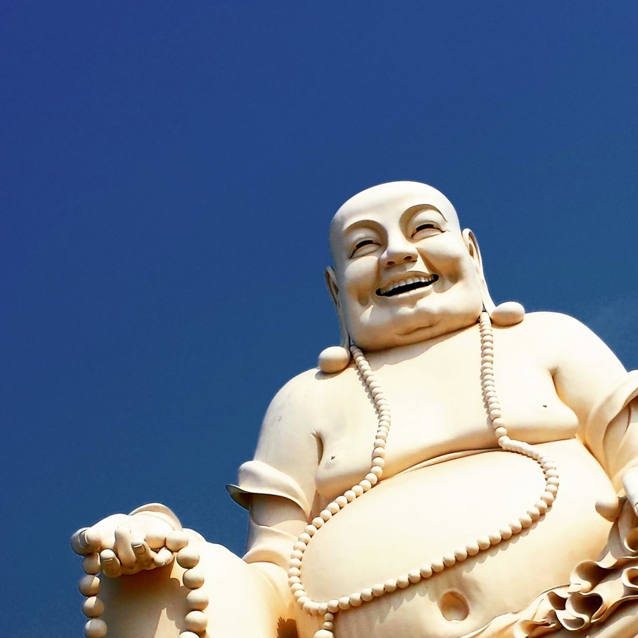 A Buddha statue smiles happily at the Vinh Trang Pagoda in the Vietnamese city of My Tho. "I was very excited to enter a Vietnamese temple ... to learn about their way of worship," said <a href="http://ireport.cnn.com/docs/DOC-1229018">Joyce Anthony</a>. 