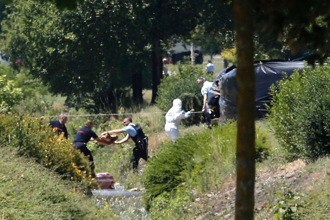 Investigators work at the enclosed area where a decapitated body was discovered at the Saint-Quentin-Fallavier factory on June 26. The severed head was found with a message, Hollande said.