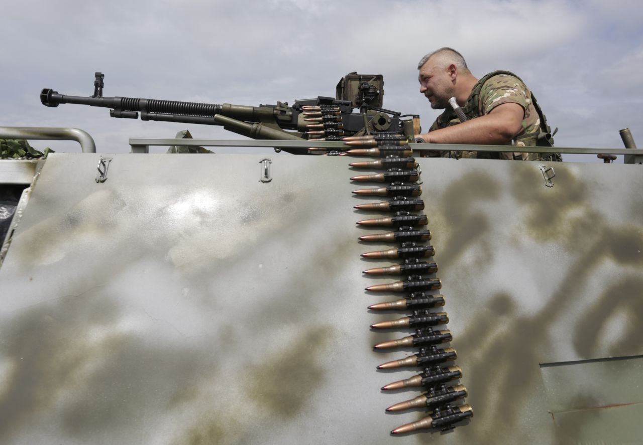 A man with a machine gun is among the Ukrainian troops standing guard in Krimskoe town of Luhansk, Ukraine, on June 25.