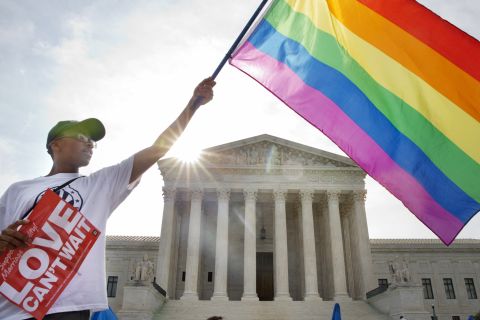 Carlos McKnight of Washington waves a flag in support of same-sex marriage outside the U.S. Supreme Court on June 26, 2015. <a href=