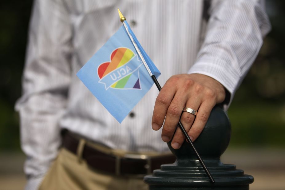 A man holds a rainbow flag outside the Supreme Court on June 26.