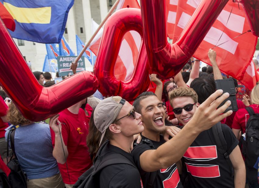 A group of same-sex marriage advocates film a video selfie in front of the Supreme Court on June 26.