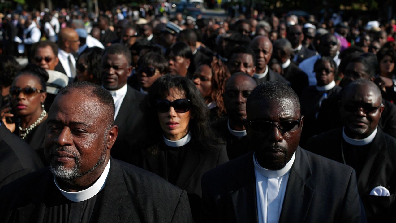 Members of the clergy wait to enter the funeral service.