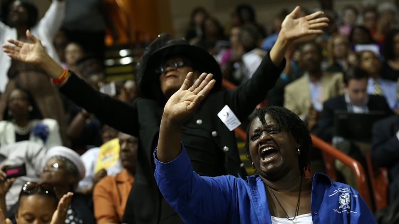 Mourners sing gospel hymns inside the arena.