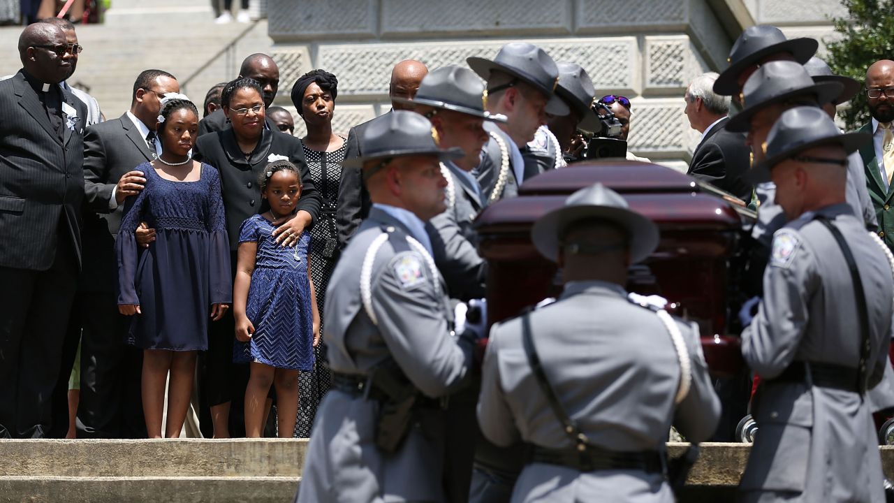As lawmakers, family and friends look on, the South Carolina Highway Patrol Honor Guard carry the coffin of church pastor and South Carolina State Sen. Clementa Pinckney to lie in repose at the Statehouse Rotunda on Wednesday, June 24, 2015 in Columbia.