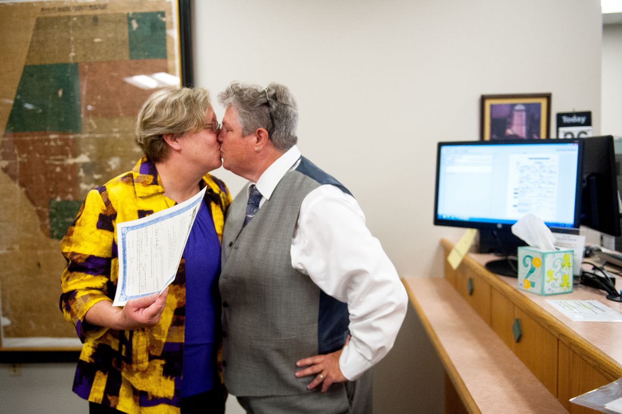 Laura Zinszer, left, and Angela Boyle kiss after receiving their marriage license June 26 in Columbia, Missouri. They were Boone County's first same-sex couple to receive their marriage license.