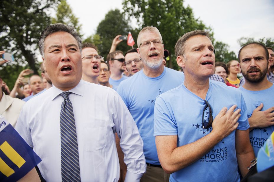 U.S. Rep. Mark Takano of California sings the national anthem June 26 with members of the Gay Men's Chorus of Washington.