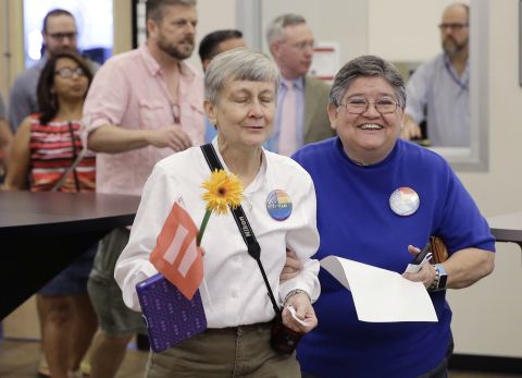 Jaque Roberts, left, and her partner of 31 years, Carmelita Cabello, arrive at the Travis County building in Austin, Texas, for a marriage license on June 26.