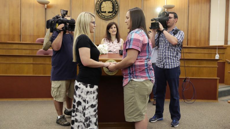 Oakland County Clerk Lisa Brown, center, marries Breanne Brodak, left, and Cortney Tucker in Pontiac, Michigan, on June 26.