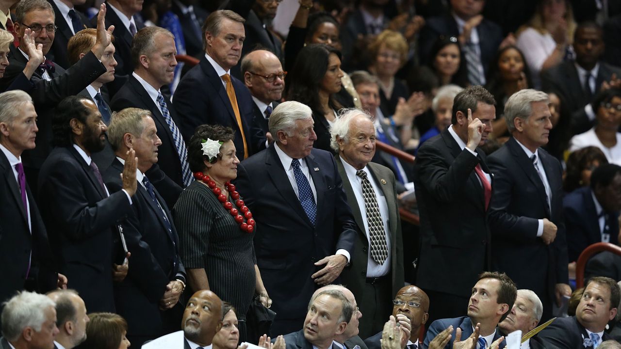 Members of Congress stand as they are introduced at the funeral service, which was held at the TD Arena in Charleston.