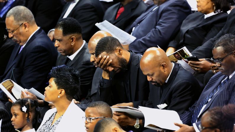 Mourners pay their respects at the funeral service.